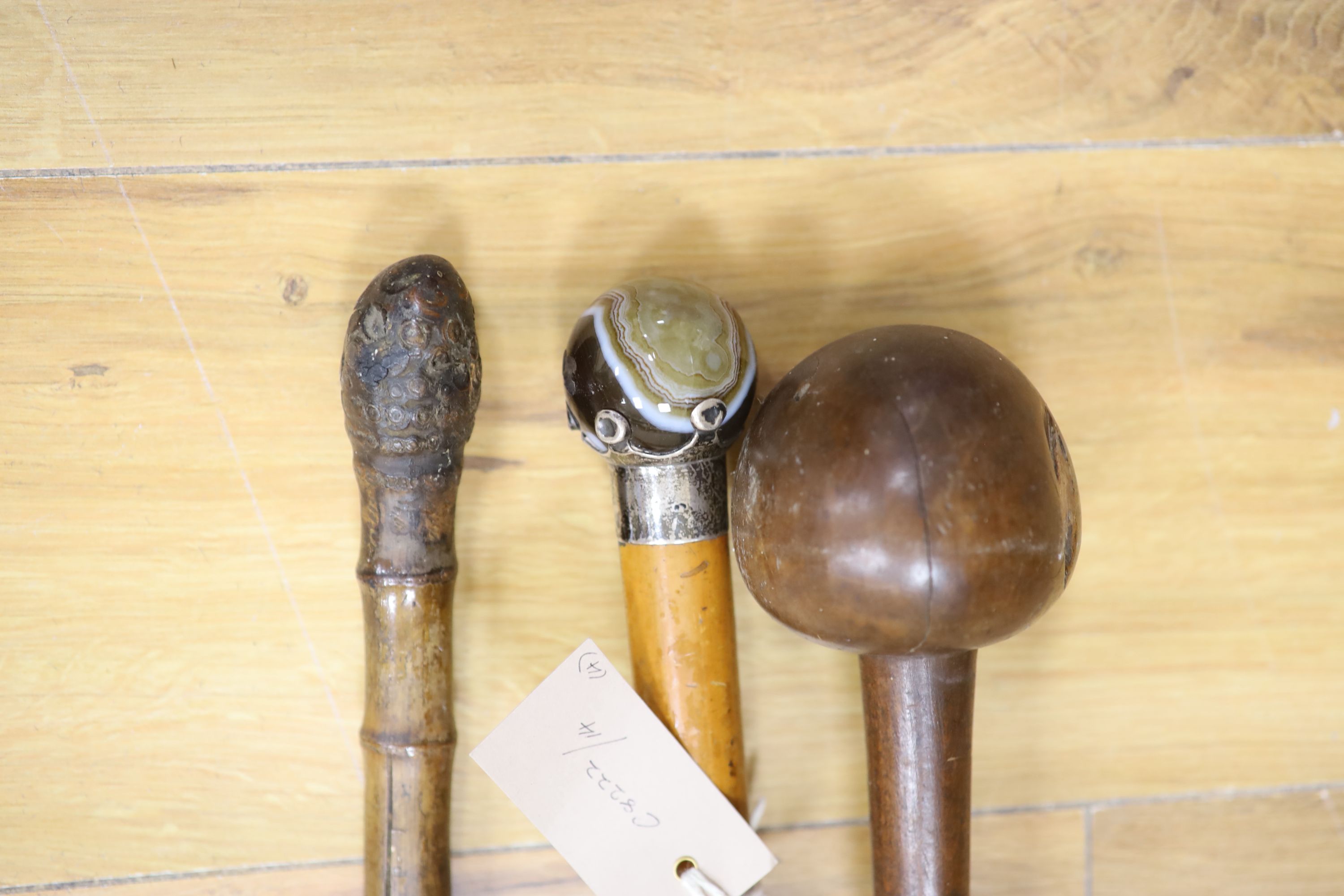 A sword stick, a knobkerrie and an agate mounted cane